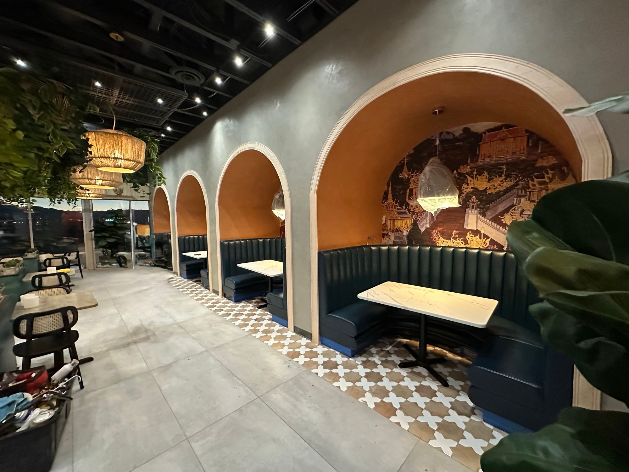 Arched restaurant booths with custom millwork and upholstered banquettes
